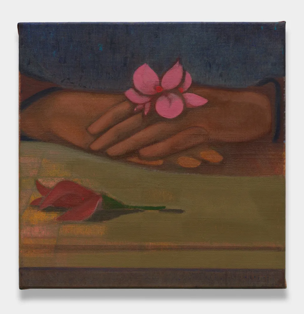 A painting shows two brown hands held together with a pink flower on top and another red flower below.
