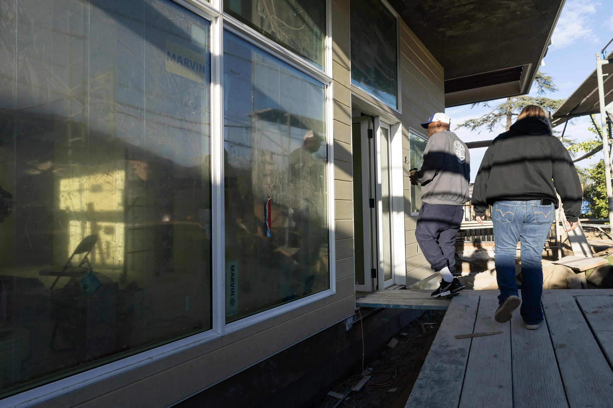 Anthony Ruffin and wife Joni Miller walk into their nearly-complete home in Altadena.