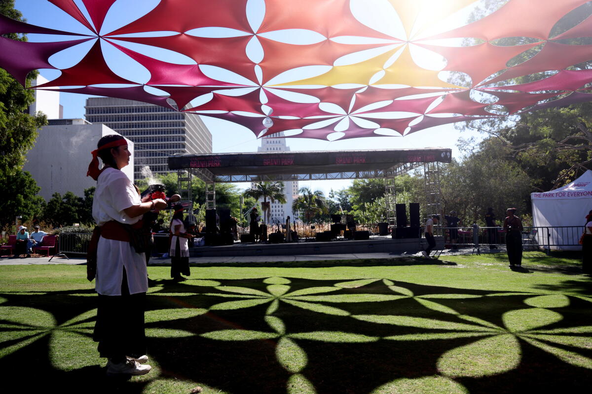 Diane Zuniga burns sage with the Ohtliyollat ​​Collective to bless the opening of the Dia De Los Muertos altar.