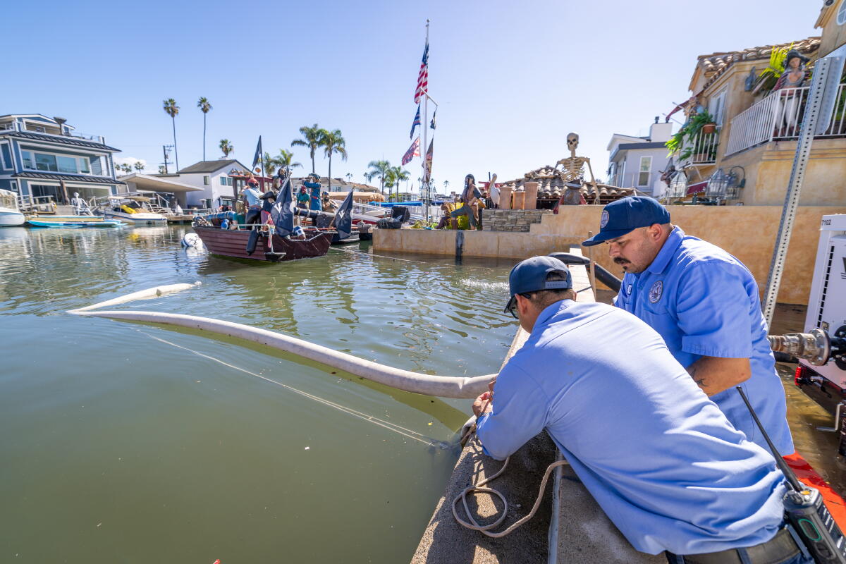Newport Beach Utilities crews pump water from flooded streets on the Newport Beach peninsula.