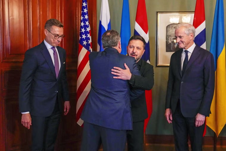 Pictured: President Volodymyr Zelensky embraces Steve Witkov as Norwegian Prime Minister Jonas Gall Storr and Finnish President Alexander Stuab look on.