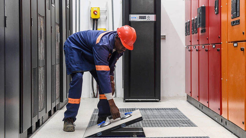 A worker inspects the main distribution board at the Delta Digital Data Center in Gaborone, Botswana.
