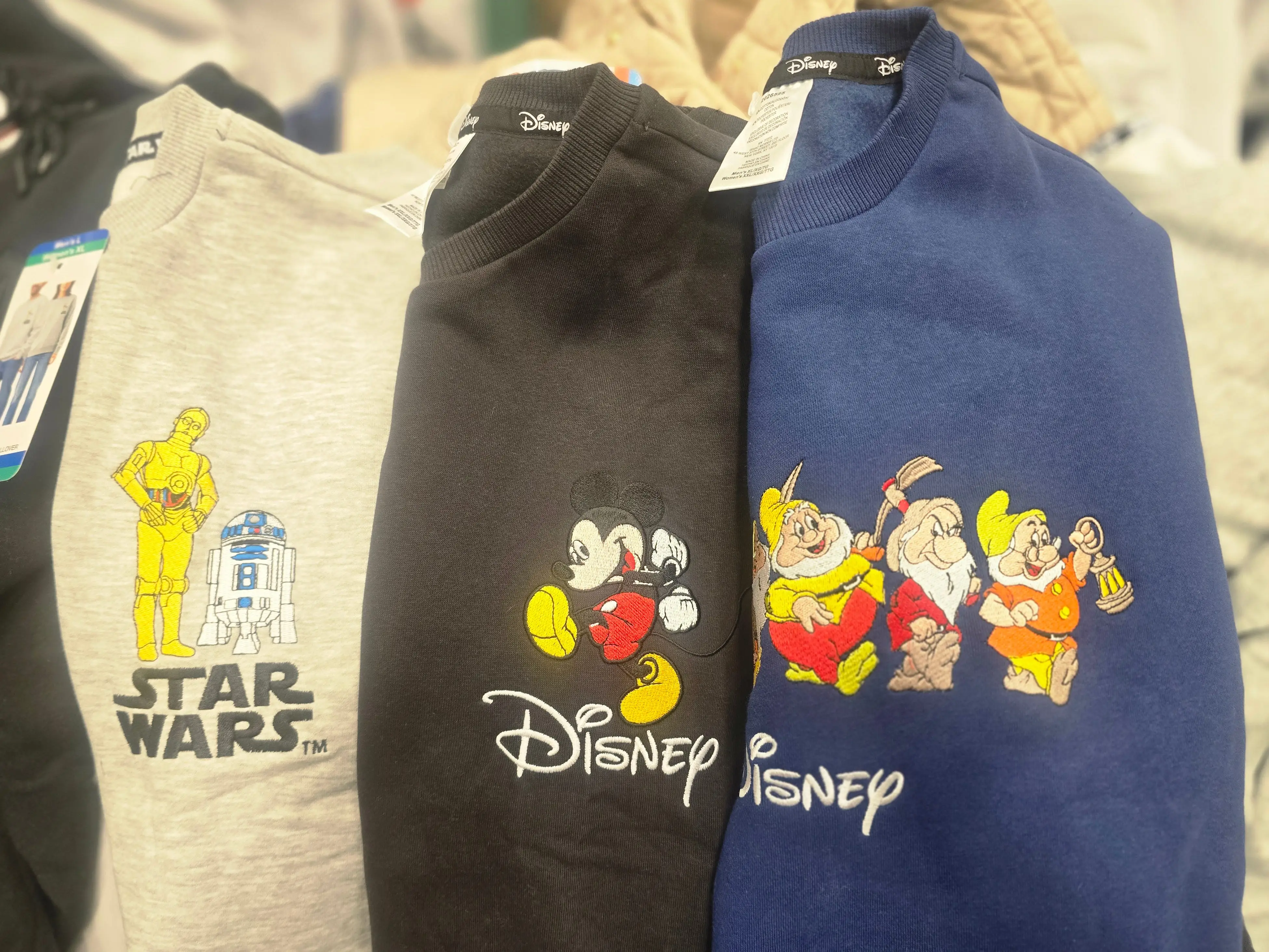 Three Disney crewneck shirts with Star Wars characters, Mickey, and Snow White.