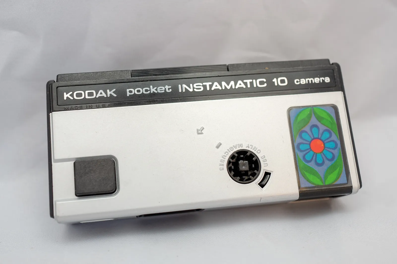 A close-up view of a Kodak Pocket Instamatic 10 film camera from the 1970s, which uses the 110 film format.