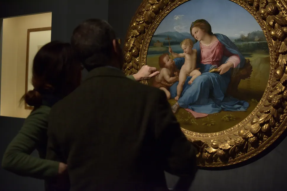 People look at the painting "Madonna con il Bambino e san Giovannino (Madonna d'Alba) Madonna and Child with Saint John" of Raffaello Sanzio in the exhibition "Raffaello 1520 - 1483" on March 4, 2020 in Rome, Italy.