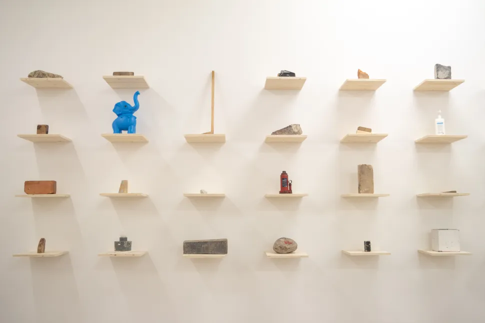small shelves arranged in a rectangular grid with makeshift doorstops