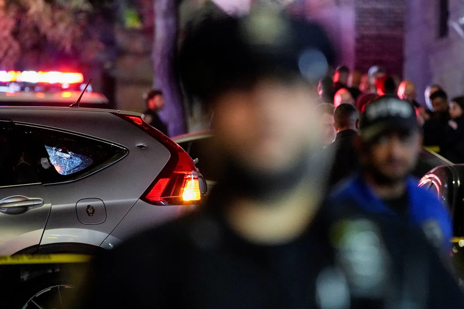 Photo of police holding bullets in front of car