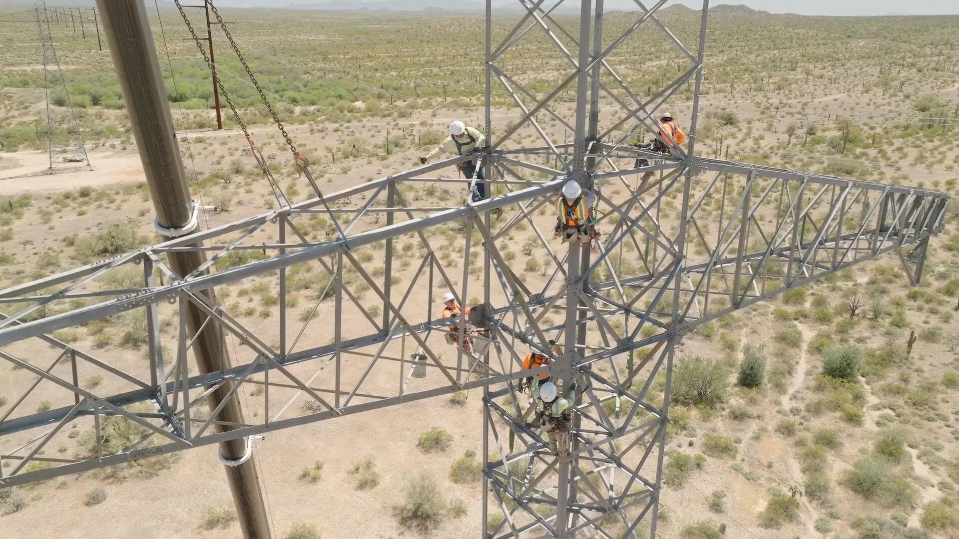 construction workers building transmission line