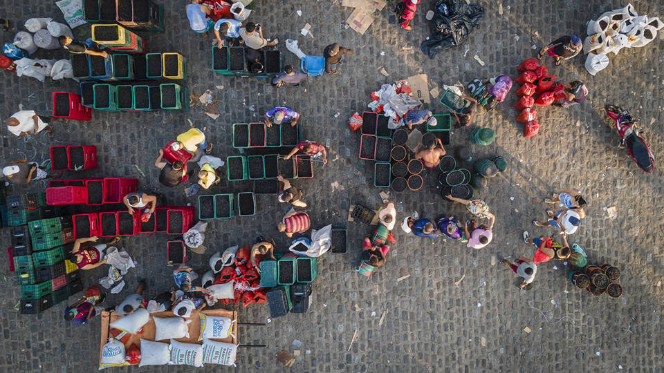 People sell açaí berries at the Ver-o-Peso market in Brazil, seen from above.