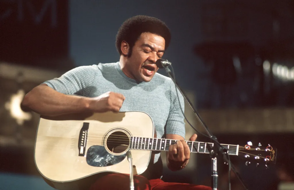 American singer, guitarist and songwriter Bill Withers performs on stage.