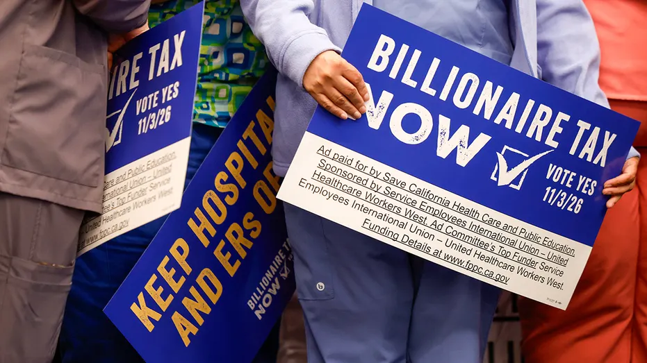 Voters hold up billionaire tax sign