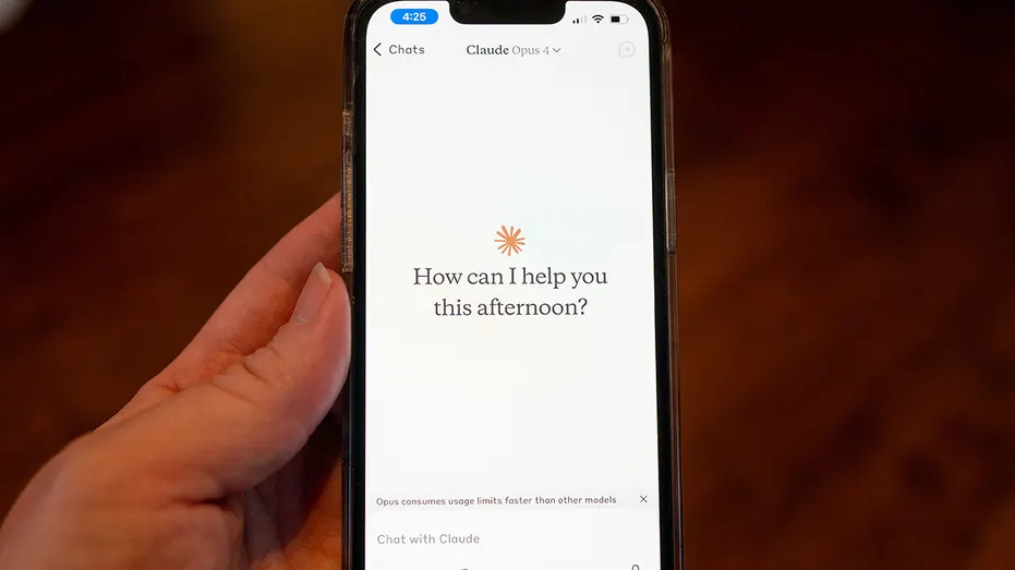 Close-up of a man's hand holding a smartphone and using the Opus 4 model in the Claude app
