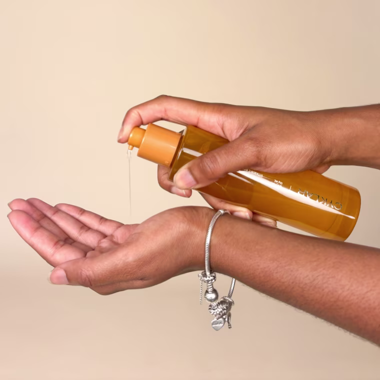 Woman applying body oil to hand