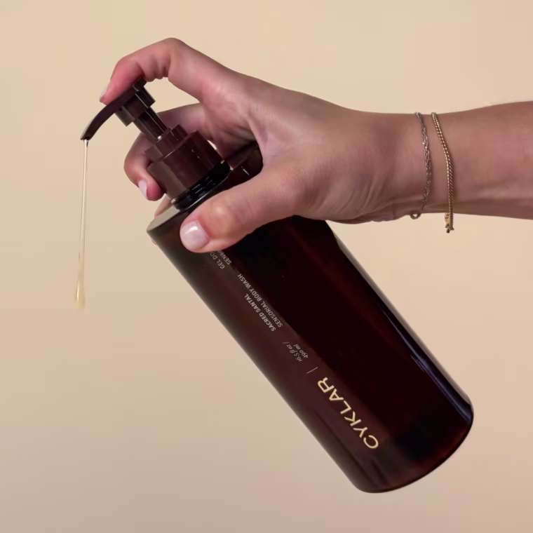 Woman dispensing body wash using pump