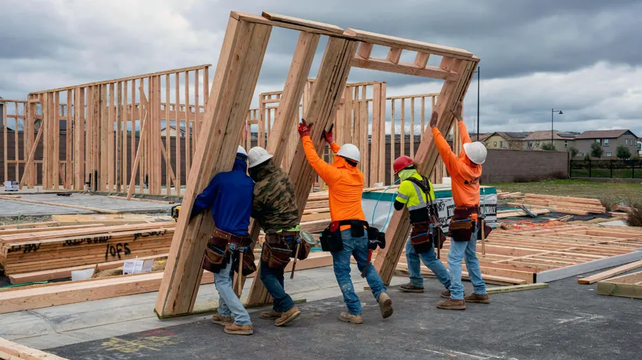 The carpenter lifted the wooden frame that was part of the house.