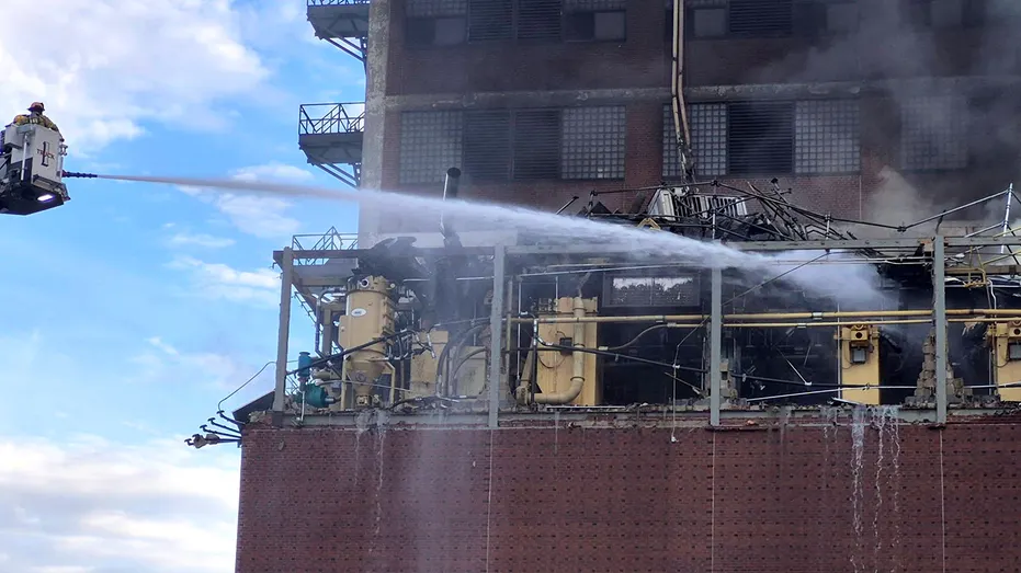 Firefighters used water hoses near the plant after the explosion and fire