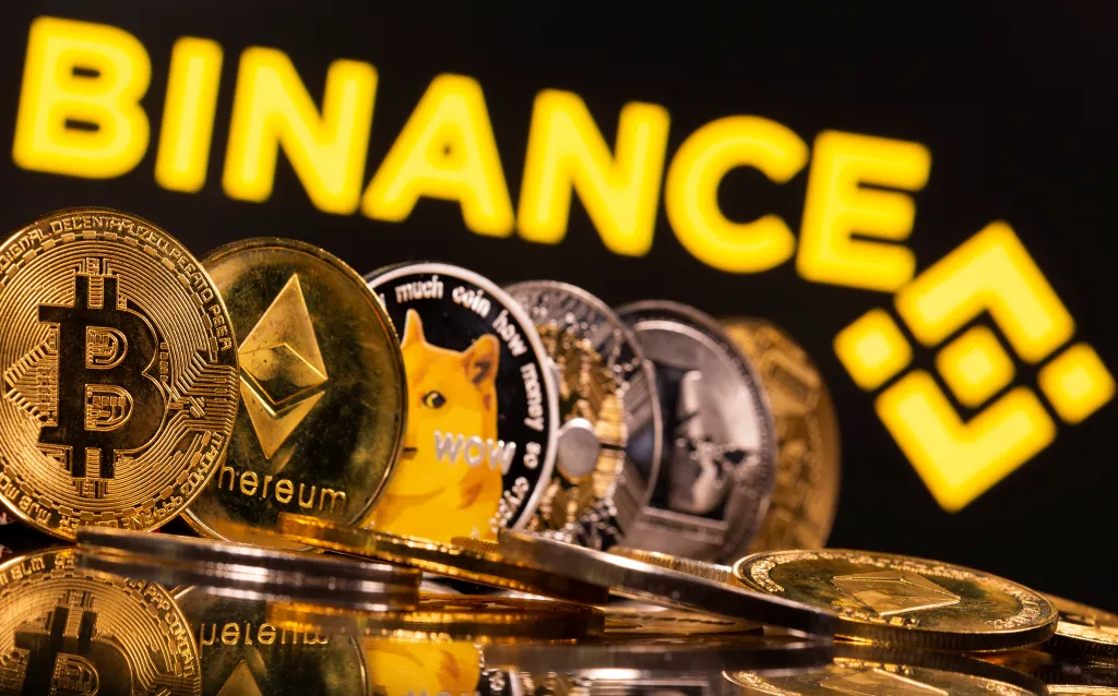 Illustration of Bitcoin, Ethereum, Dogecoin, Ripple and Litecoin in front of Binance logo.