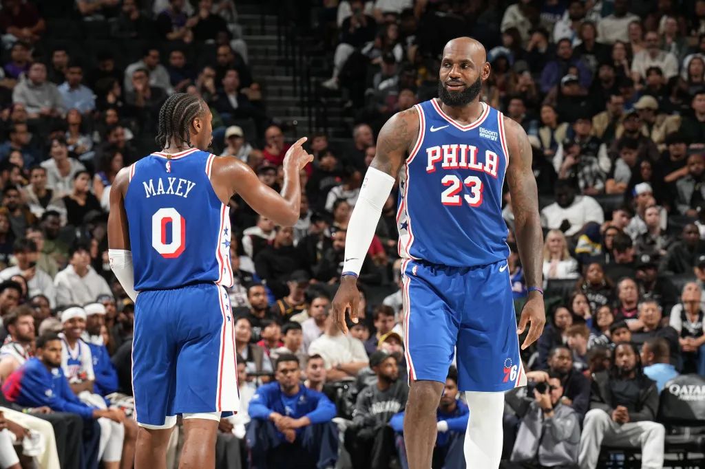 Philadelphia 76ers' Tyrese Maxey and LeBron James talk during the game.